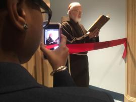 Cardinal Sean O'Malley at the re-dedication of Lower Mills campus: At left, seventh grader Orianeh Byron-Gabelus captured the scene on her phone. Ed Forry photo